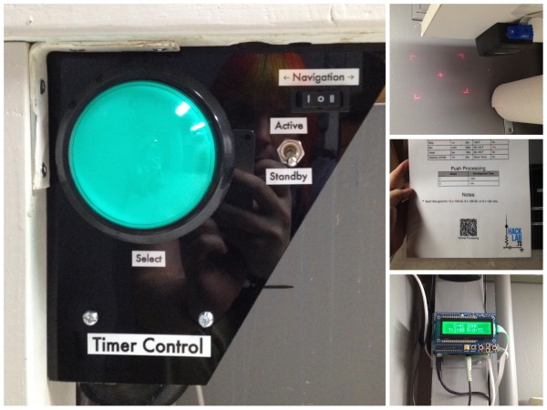 On the left, a control panel with one large green button and a number of smaller switches. In the upper right, a barcode scanner making a laser crosshair on the wall. In the upper middle, a paper sheet with a 2D barcode at the bottom. In the lower right, a green LCD display that says C-41 Soak and the time remaining.